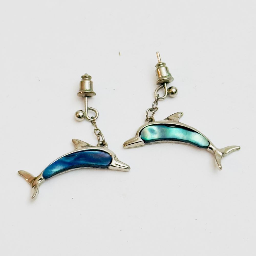 Pair of silver-toned abalone‎ shell dolphin dangle earrings.